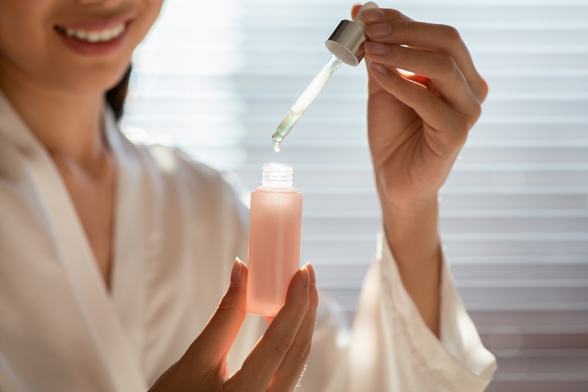 Cropped of woman holding bottle with serum