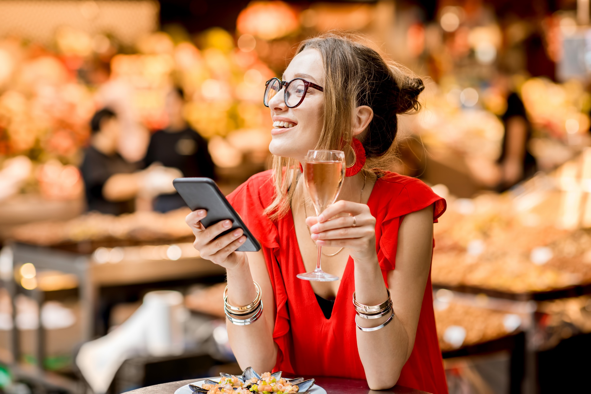 Woman eating mussels at the food market