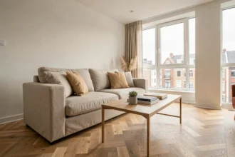 Salon modernement aménagé en home staging avec canapé neutre, coussins en lin et parquet chêne clair pour valoriser un bien immobilier